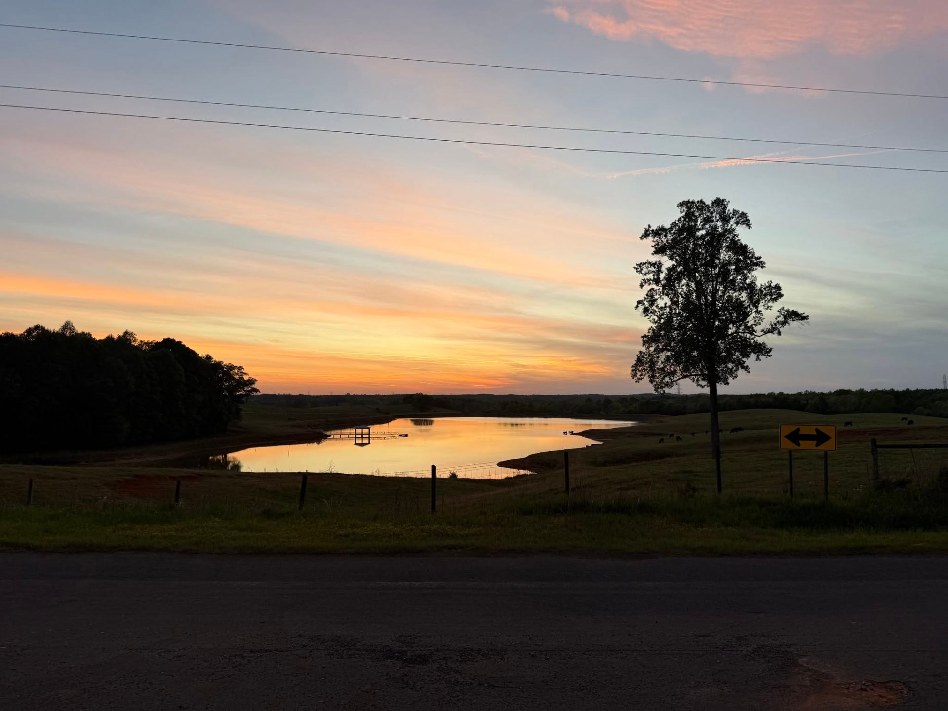 Sunset over a pond and rolling pasture in rural North Carolina