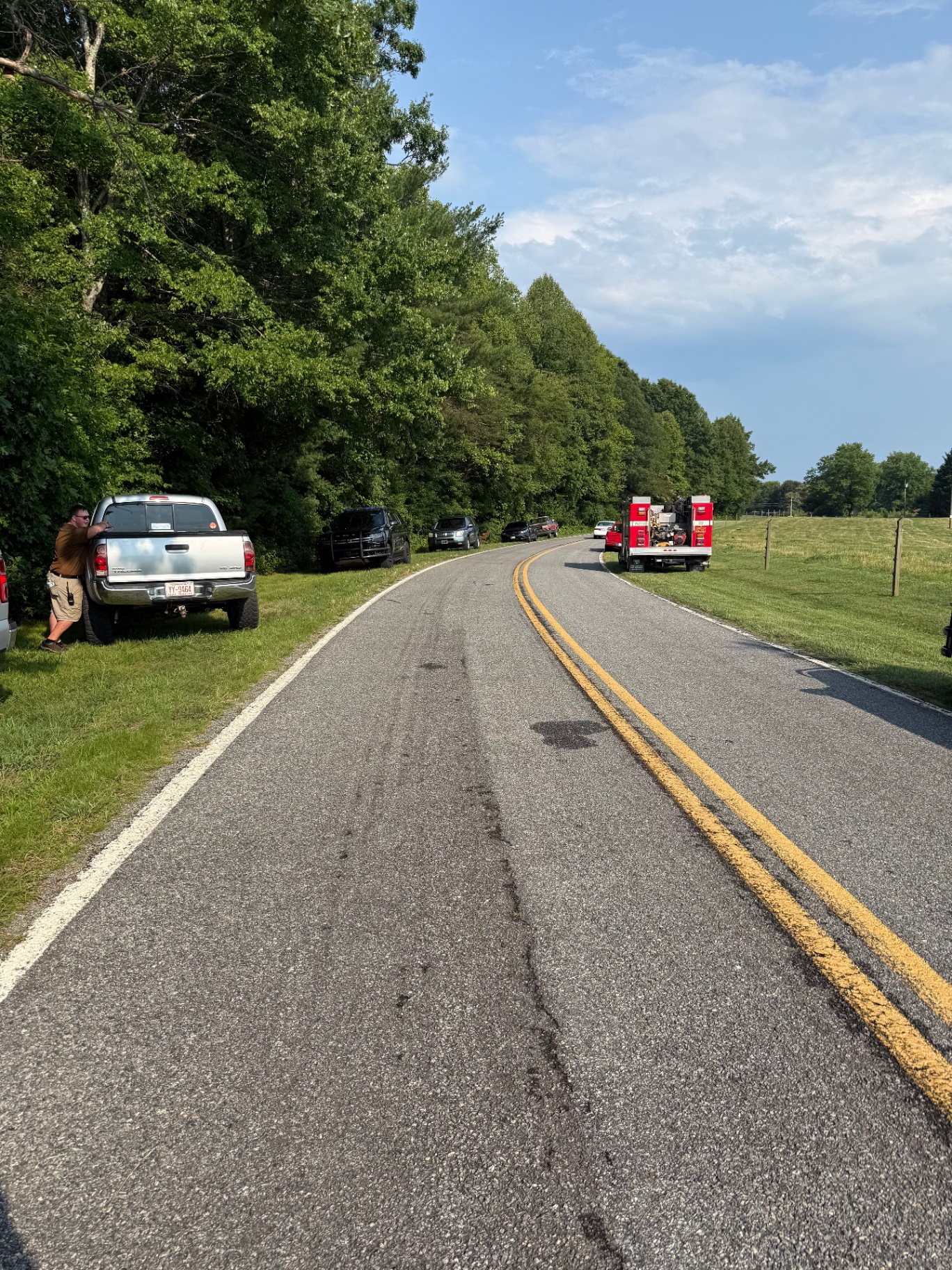 Brush truck staged along a country road for a recovery